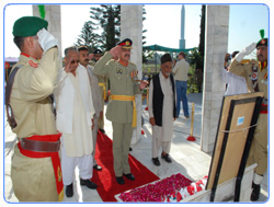 Brigadier Iftikhar Ayub Khan, Station Commander Jhelum presenting salute at the Grave of Captain Muhammad Sarwar Shaheed