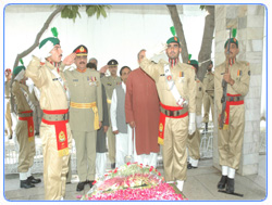 Major General Nasser Khan Janjua, General Officer Commanding presenting salute at the Grave of Major Aziz Bhatti