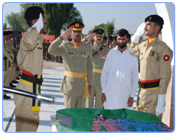 Brigadier Khalid Mehmood Ch, Local Formation Commander, presenting salute at the Grave of Sawar Muhammad Hussain Shaheed 